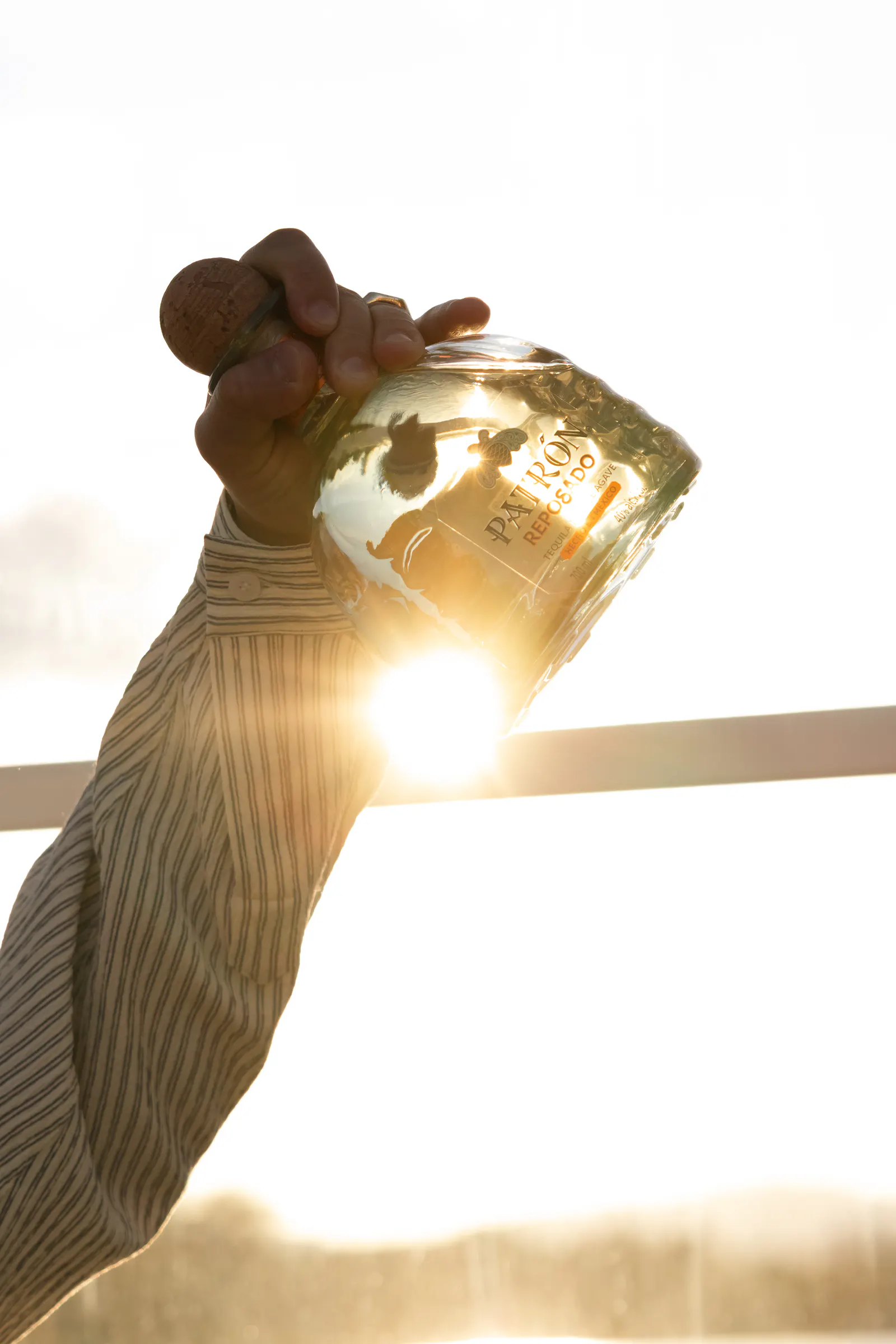 Eine Flasche wird vor der untergehenden Sonne ausgeschenkt